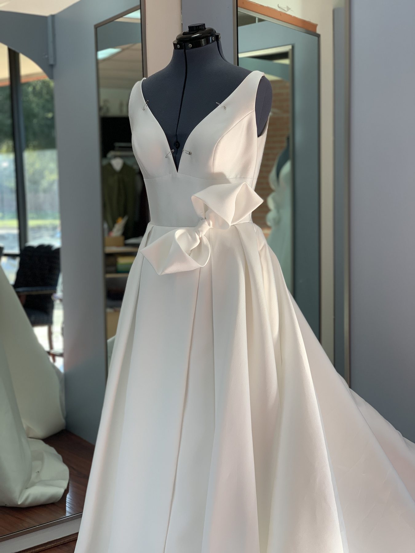 Wedding gown mid-alteration on a mannequin at GM Custom Clothier, a Sugar Land, TX bridal tailor