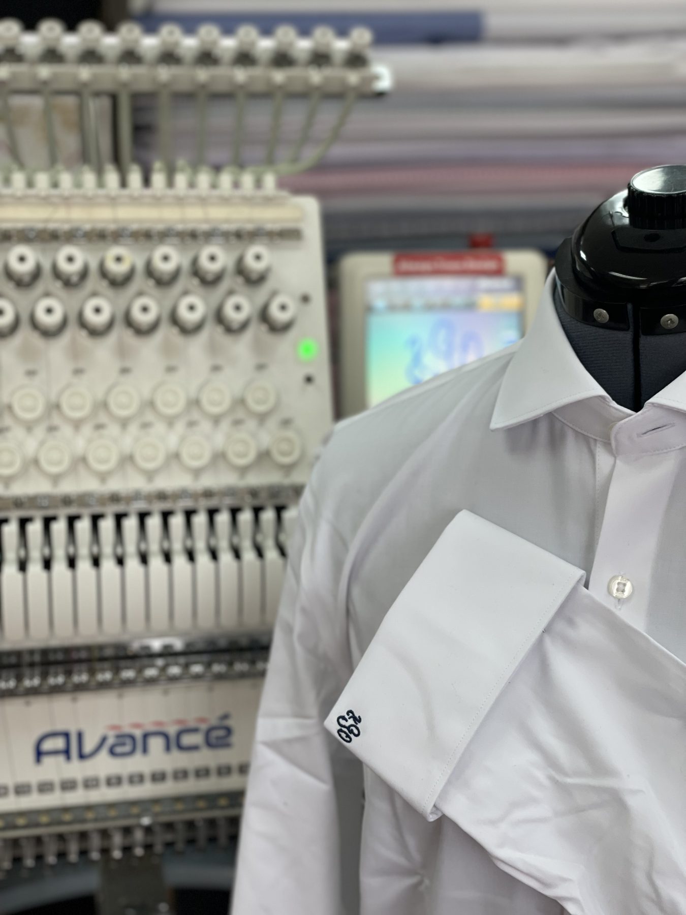 Monogrammed dress shirt on an embroidery machine at GM Custom Clothier's Sugar Land, TX tailoring atelier